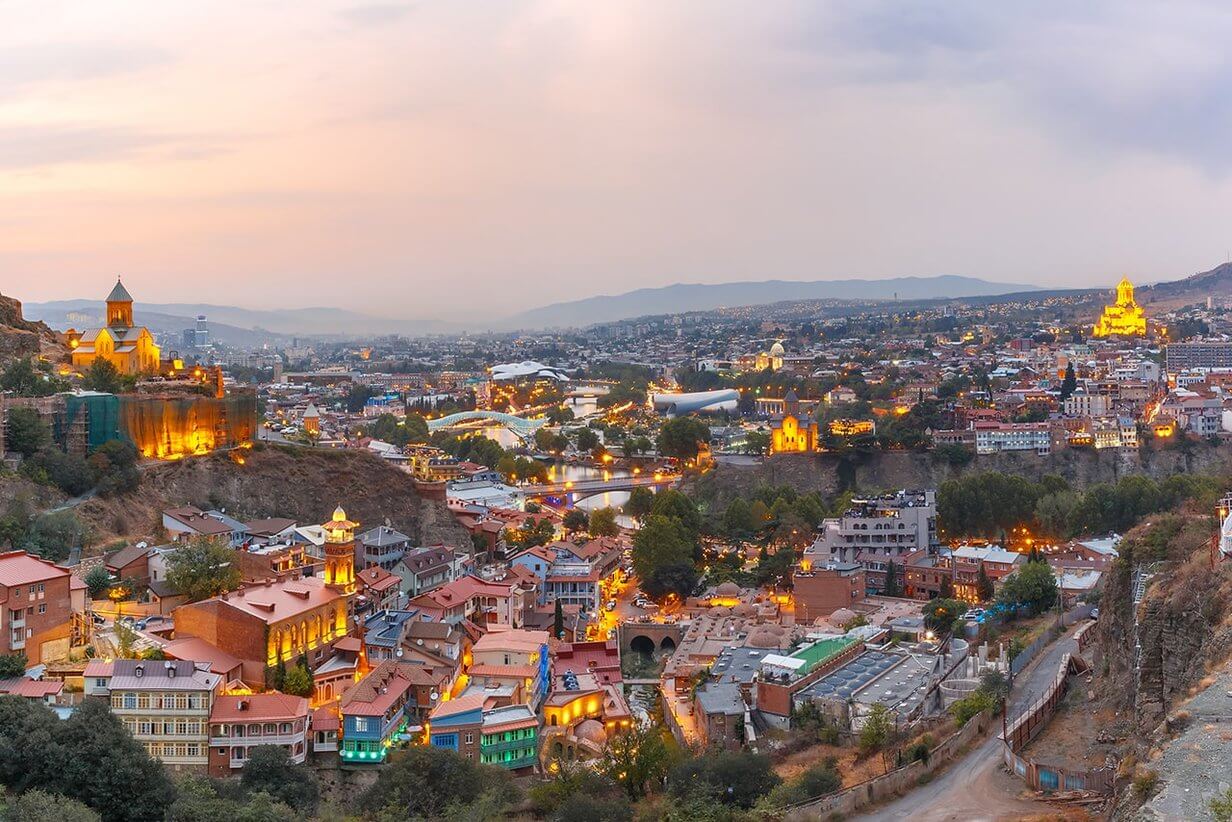 Panorama der georgischen Hauptstadt Tiflis bei Sonnenuntergang